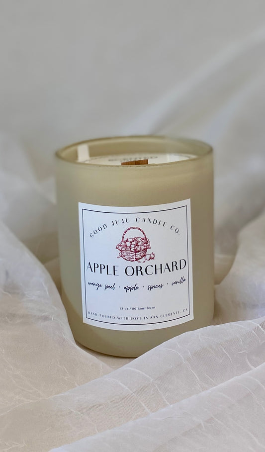 Candle with 'Apple Orchard' label on a soft white background
